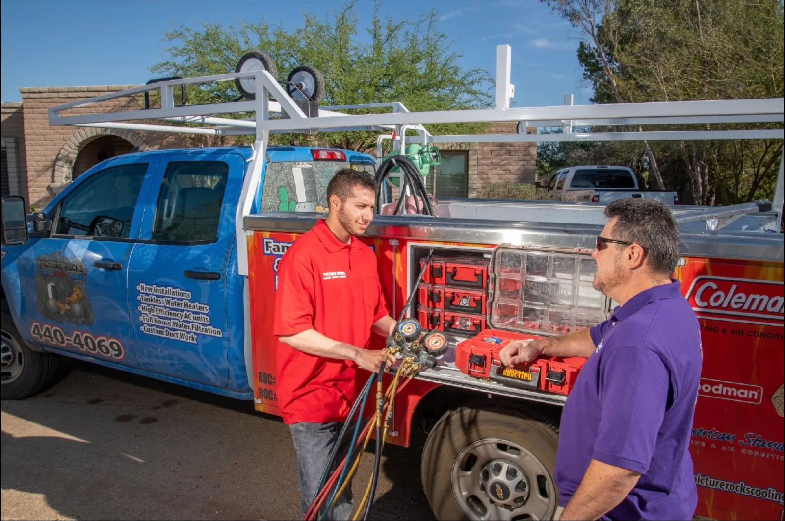 Abel from Picture Rocks Cooling running a diagnostic gauge at a service truck while explaining the reading to a homeowner.